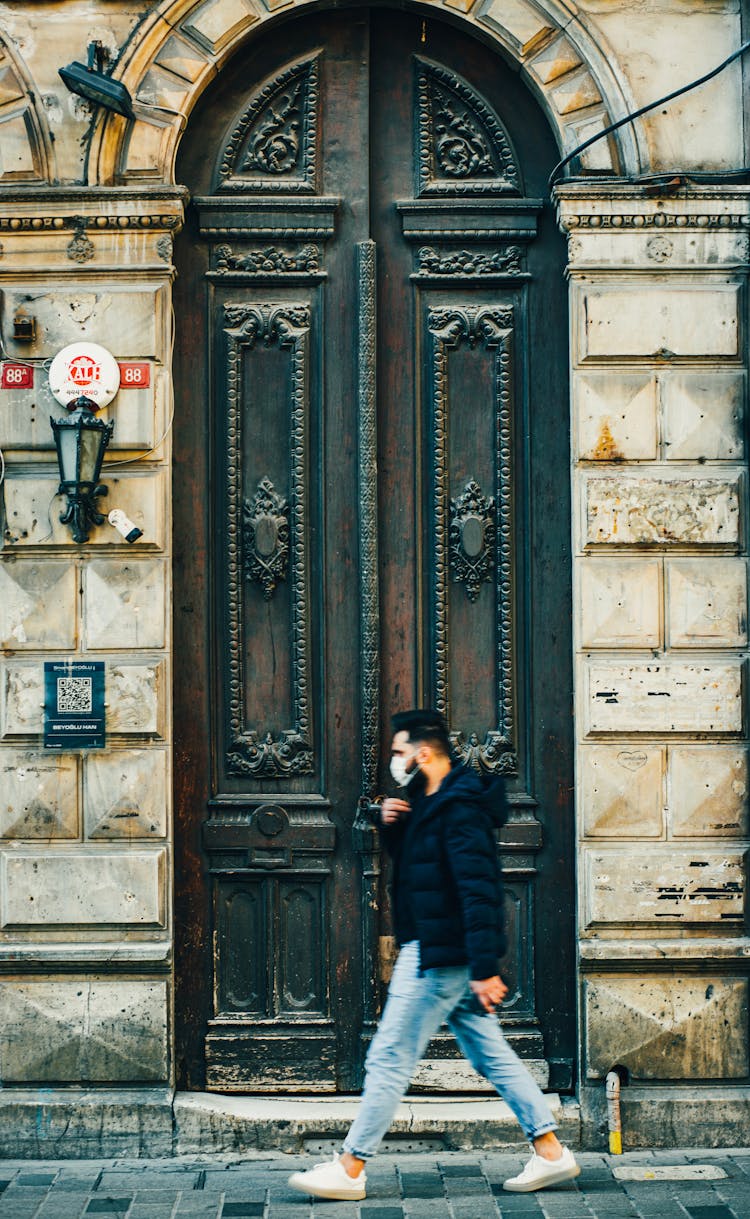 Man In Mask Walking On Street