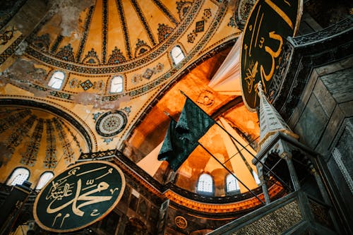 From below of aged ornamental dome with arched windows in Hagia Sophia Mosque in Istanbul