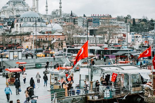 People walking on sidewalk on street against famous historic mosques in Istanbul in Turkey in cloudy day