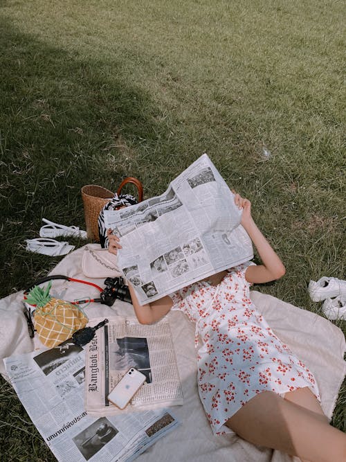 Free A Person Reading a Newspapers Stock Photo