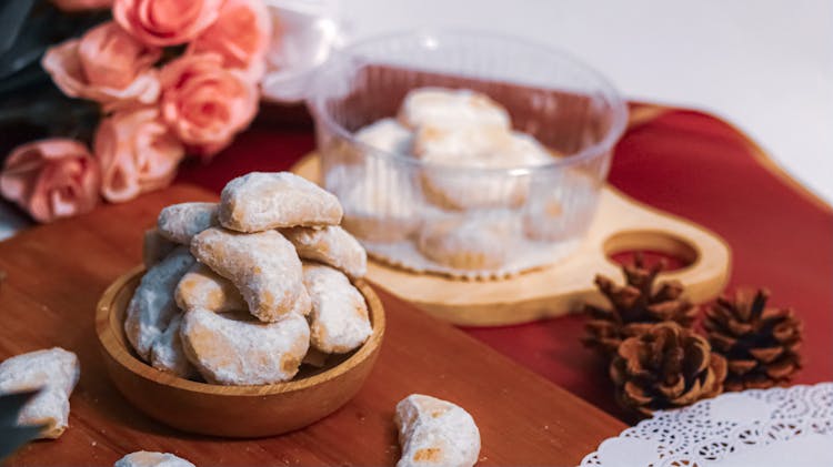 White Glazed Cookies On Brown Wooden Bowl