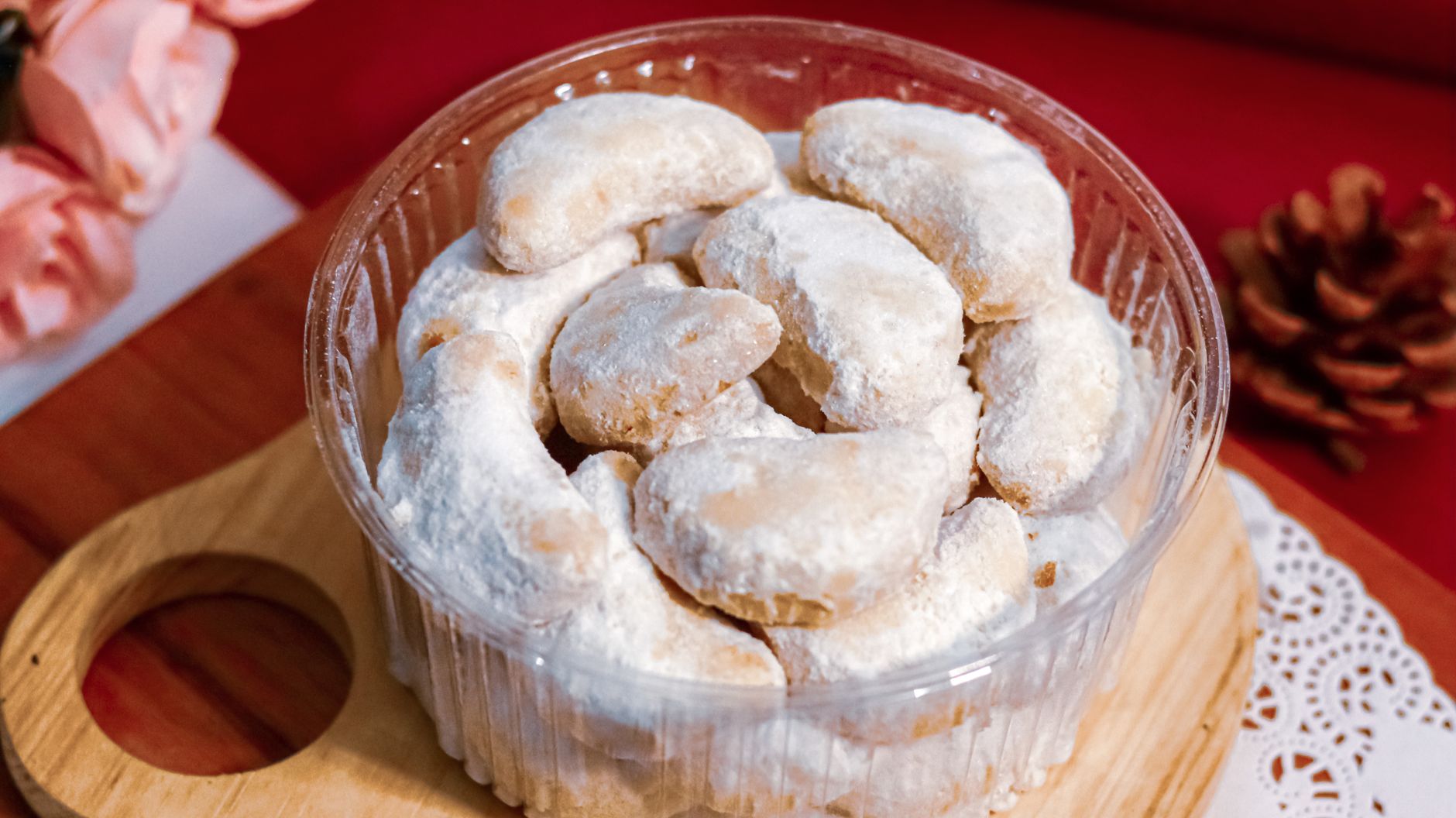 Three almond crescent cookies on parchment paper