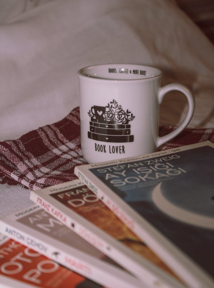 White Ceramic Mug On White And Red Plaid Textile