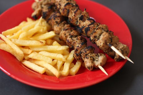 Close Up Photo of Grilled BBQ and Fries on Red Plate