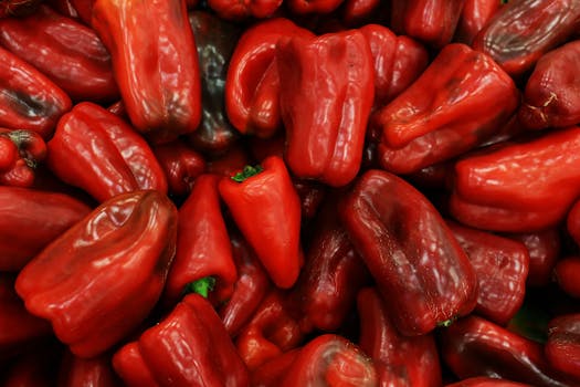 Close-up of fresh red bell peppers showcasing vibrant color and texture, ideal for cooking.