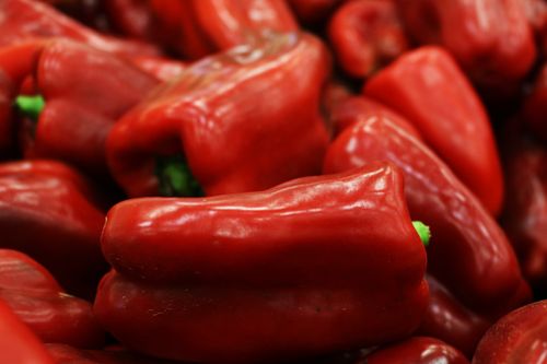Free A close-up of fresh, vibrant red bell peppers showcasing their natural color. Stock Photo