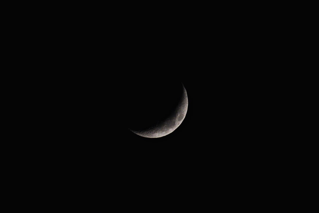 a clear crescent moon captured against a dark night sky showcasing nat