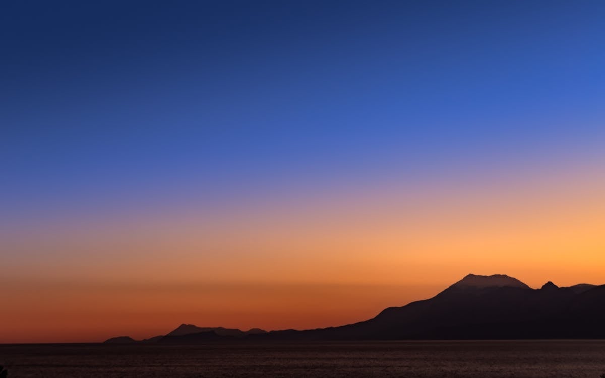 Silhouette of Mountain during Dawn 