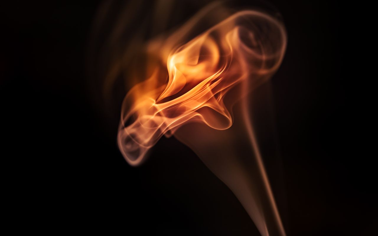 captivating abstract image of a flame swirling in darkness showcasing