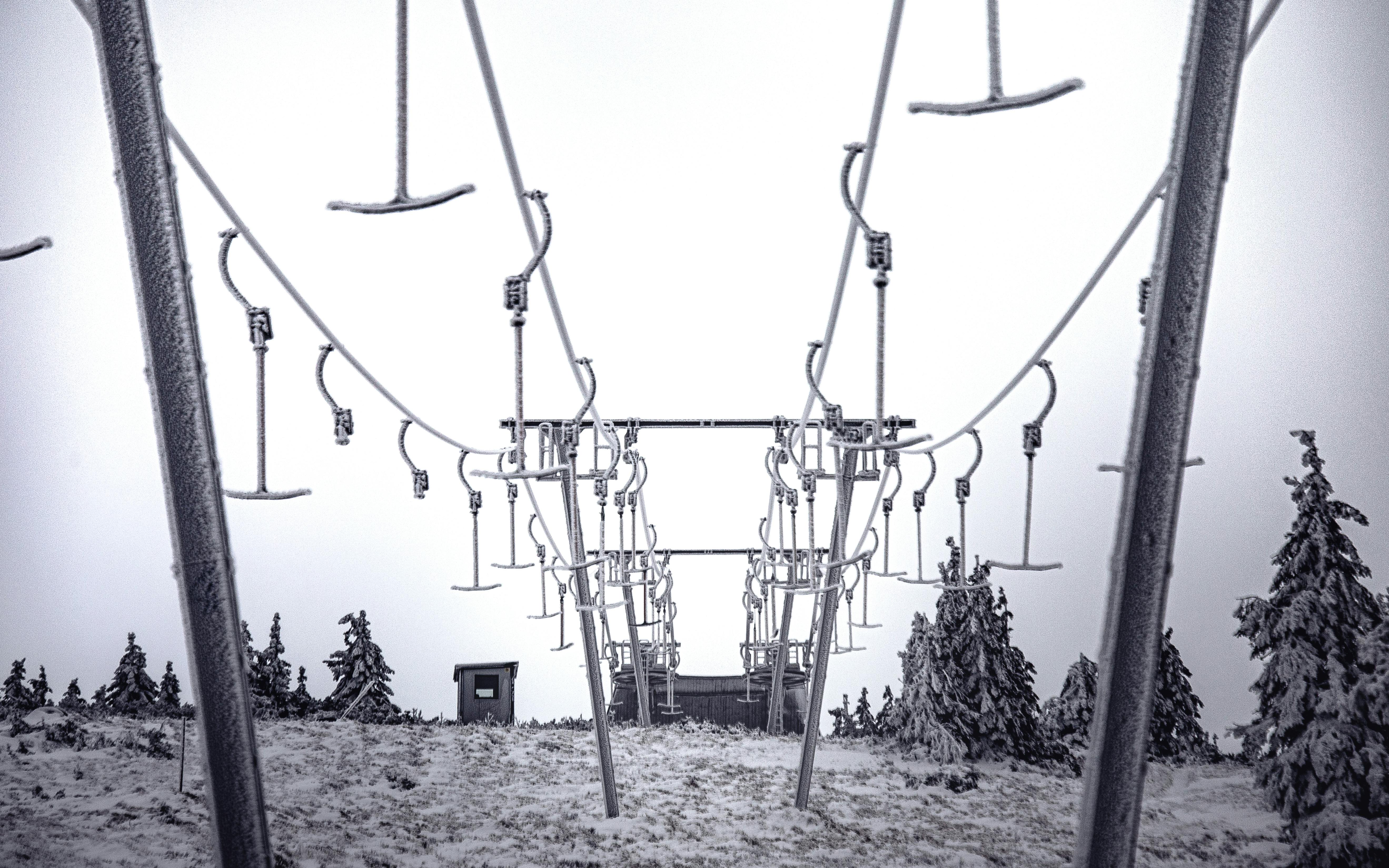 Snow-covered ski lift in Karkonosze National Park, Poland, capturing a winter landscape.
