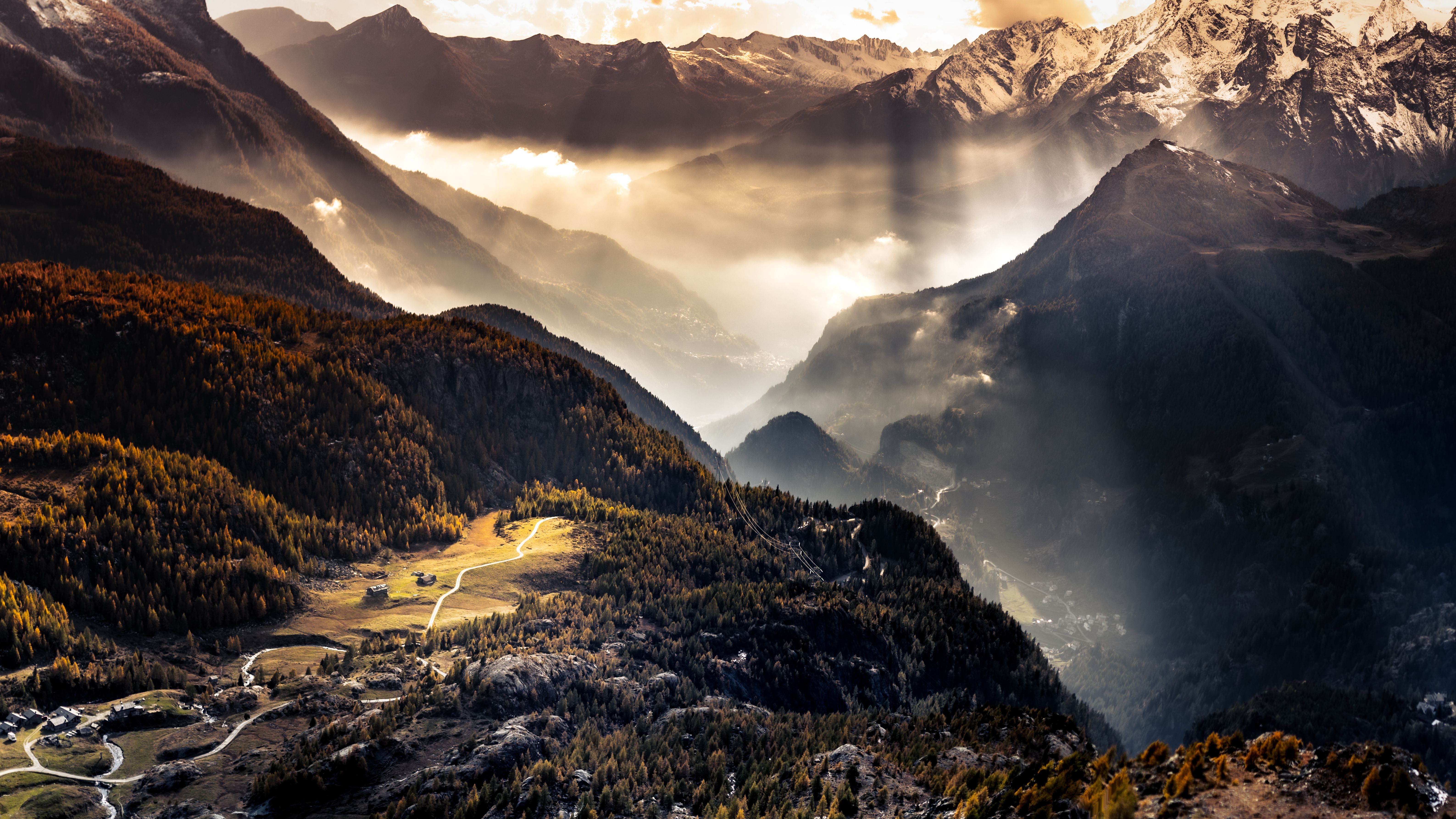 Stunning view of mountain peaks with sunlight and valleys in Lombardy, Italy.