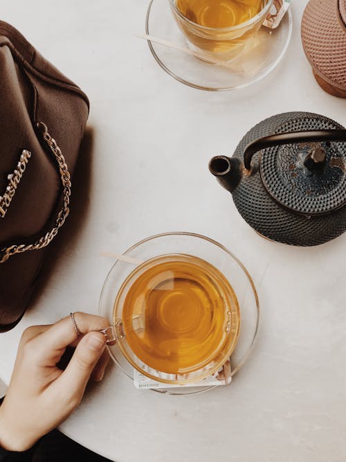 Woman with glass cup of herbal tea