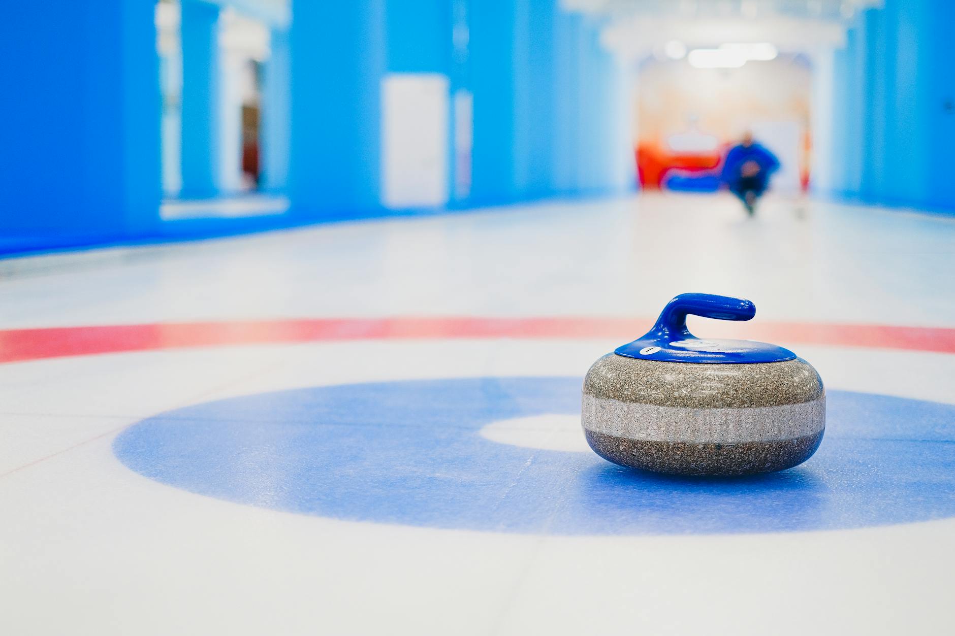 Curling stone placed in house on ice rink