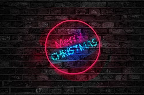 Free Turned on Red and Blue Merry Christmas Neon Sign Stock Photo