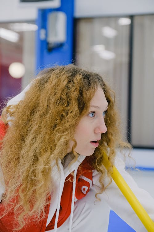 Young woman with long wavy hair competing in arena