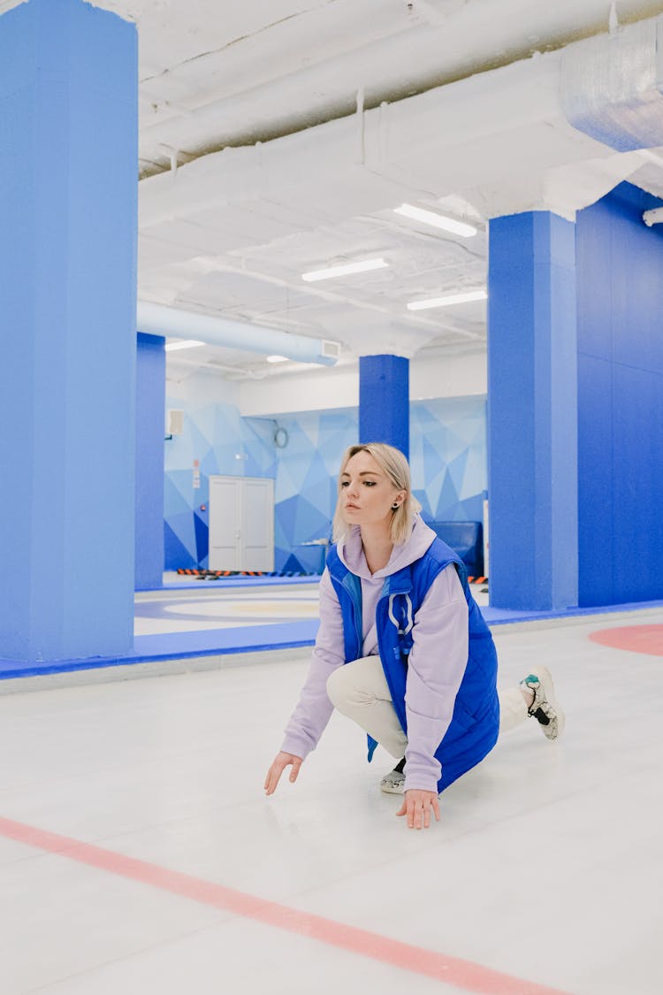 Sportswoman On Ice Sheet During Curling Game