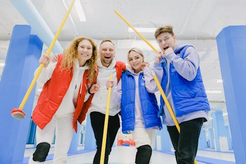 Delighted curling players with brooms