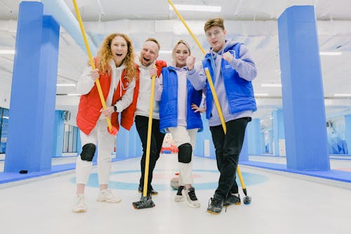 Carefree curling players on ice