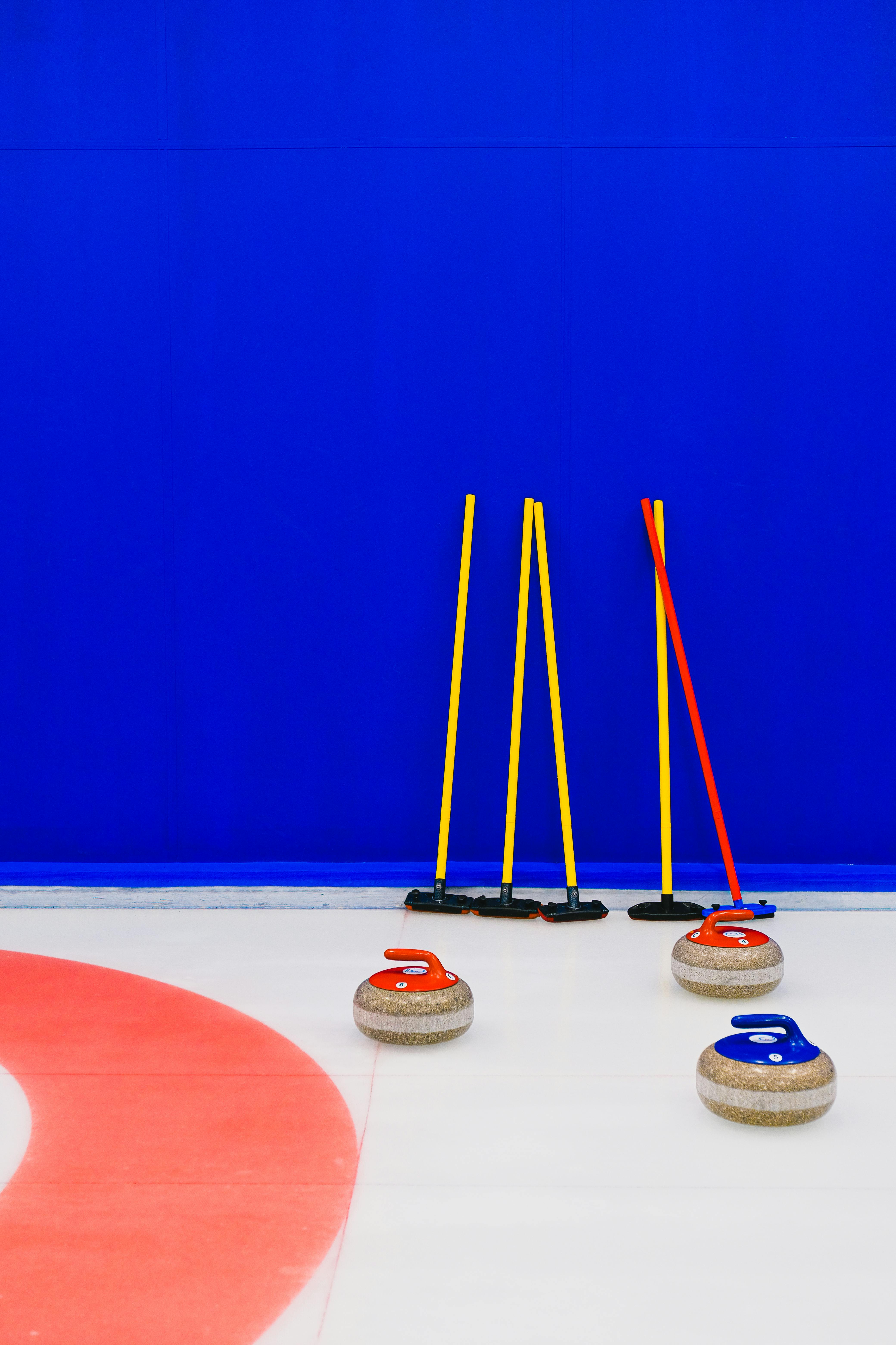 curling equipment near blue wall