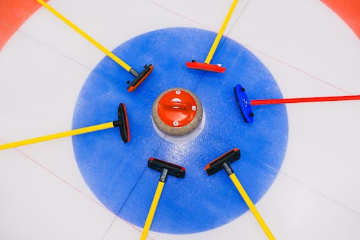 A vibrant image showcasing a curling stone surrounded by brooms on an ice rink target.