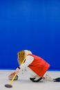 Faceless sportswoman with curling stone and broom