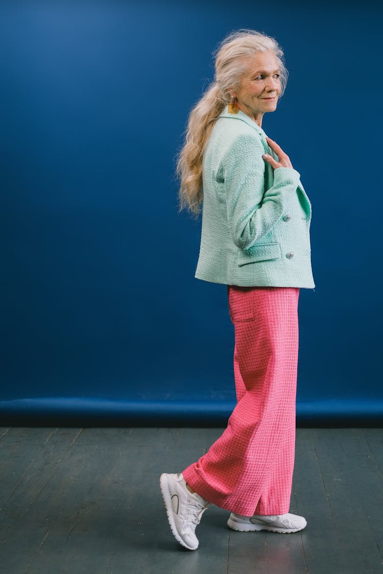 Content Aged Female Model Against Blue Backdrop