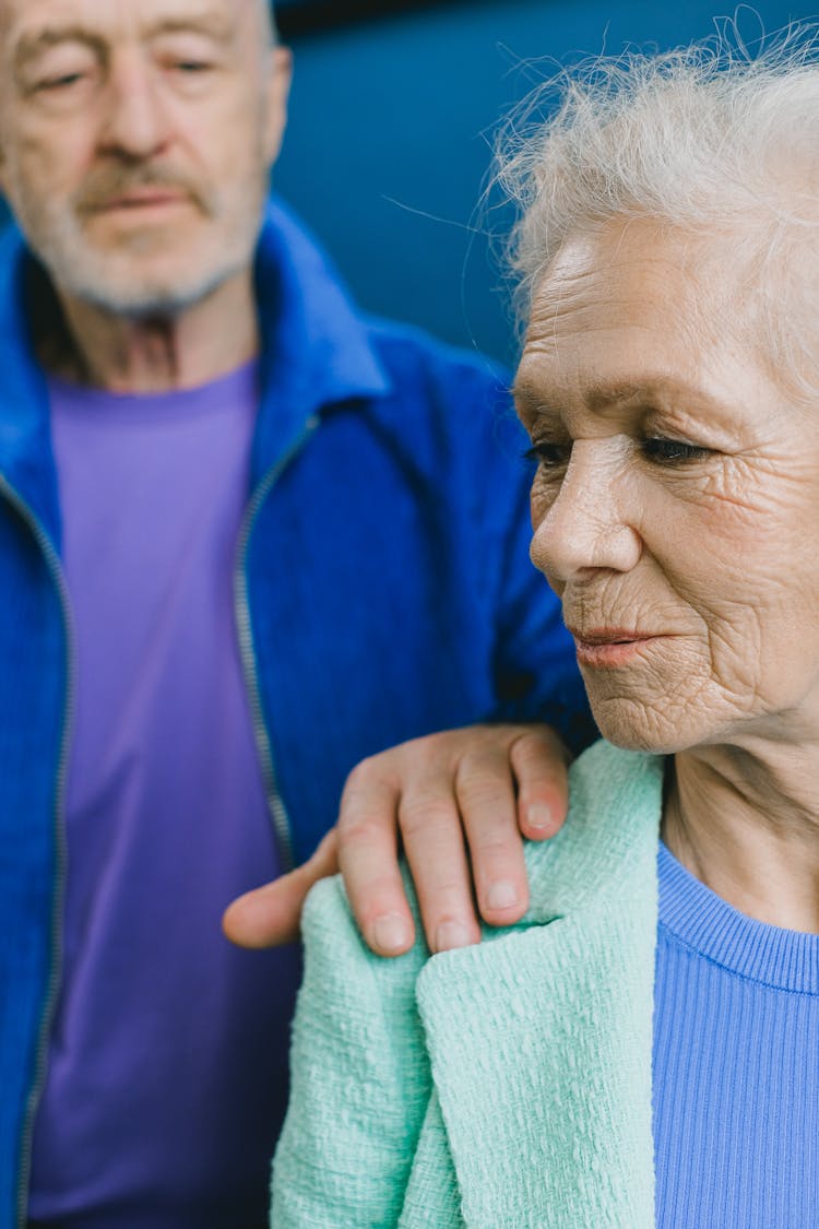 Elderly Man Holding A Woman On Her Shoulder