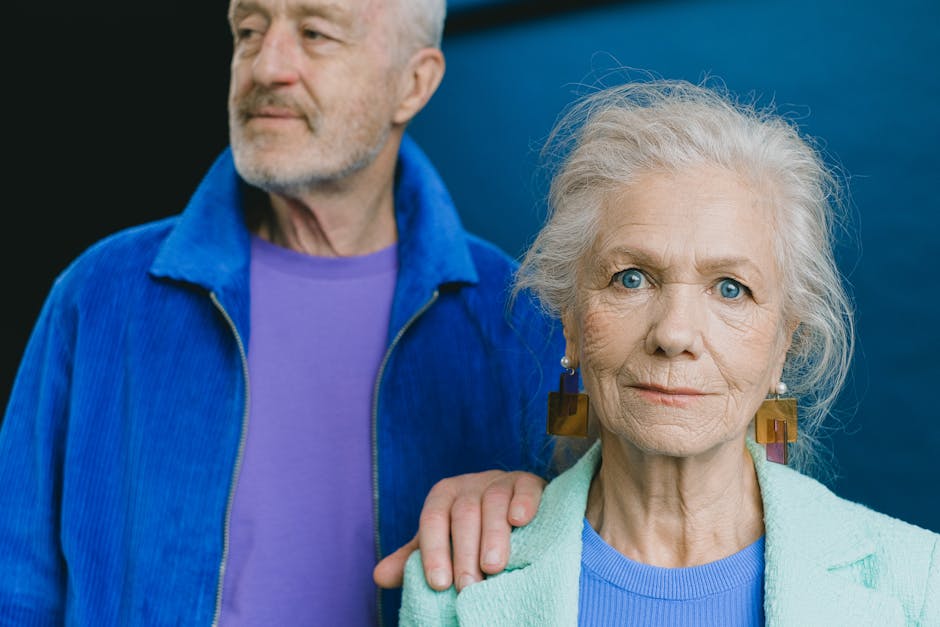 Portrait of an elegant senior couple wearing vibrant blue clothing, depicting timeless style and grace.