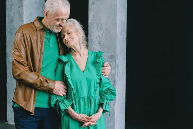 Happy Elderly Couple Hugging Outdoors