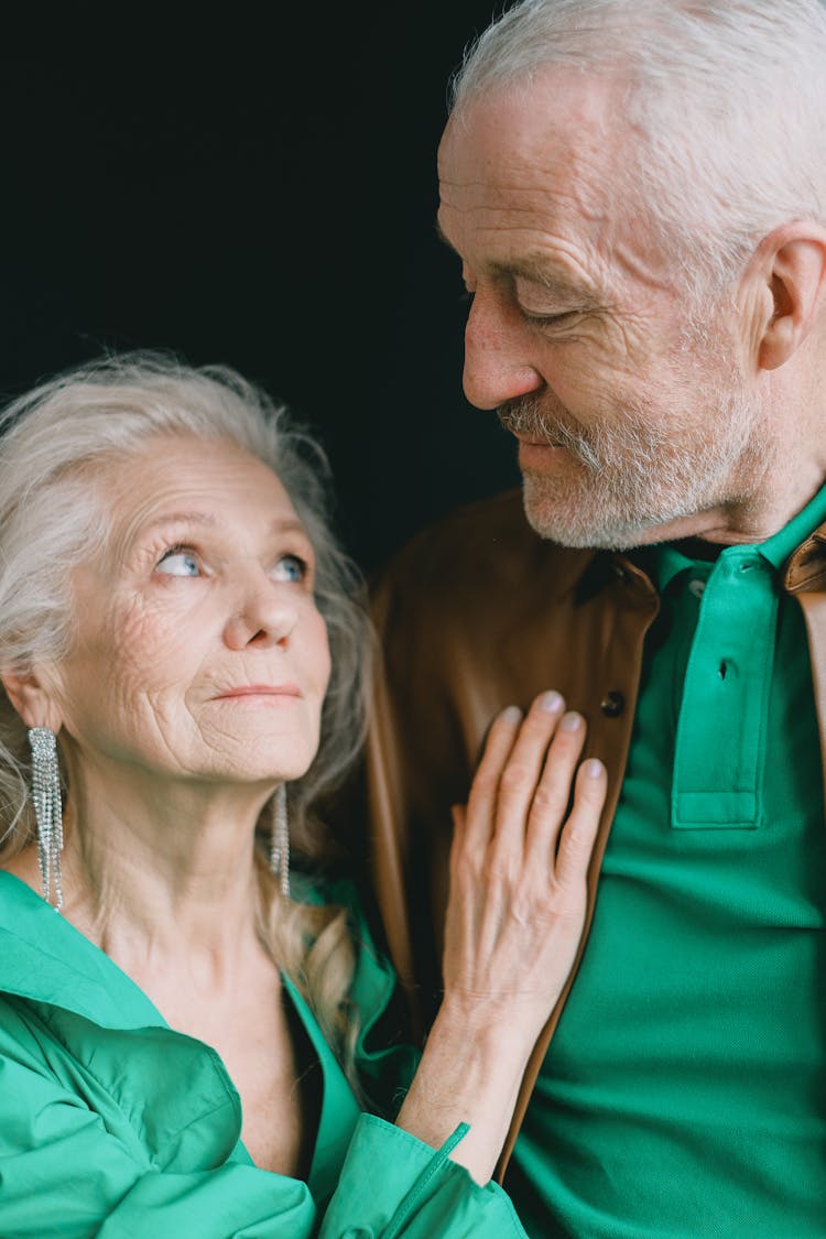 Happy Elderly Couple Hugging Looking In Eyes