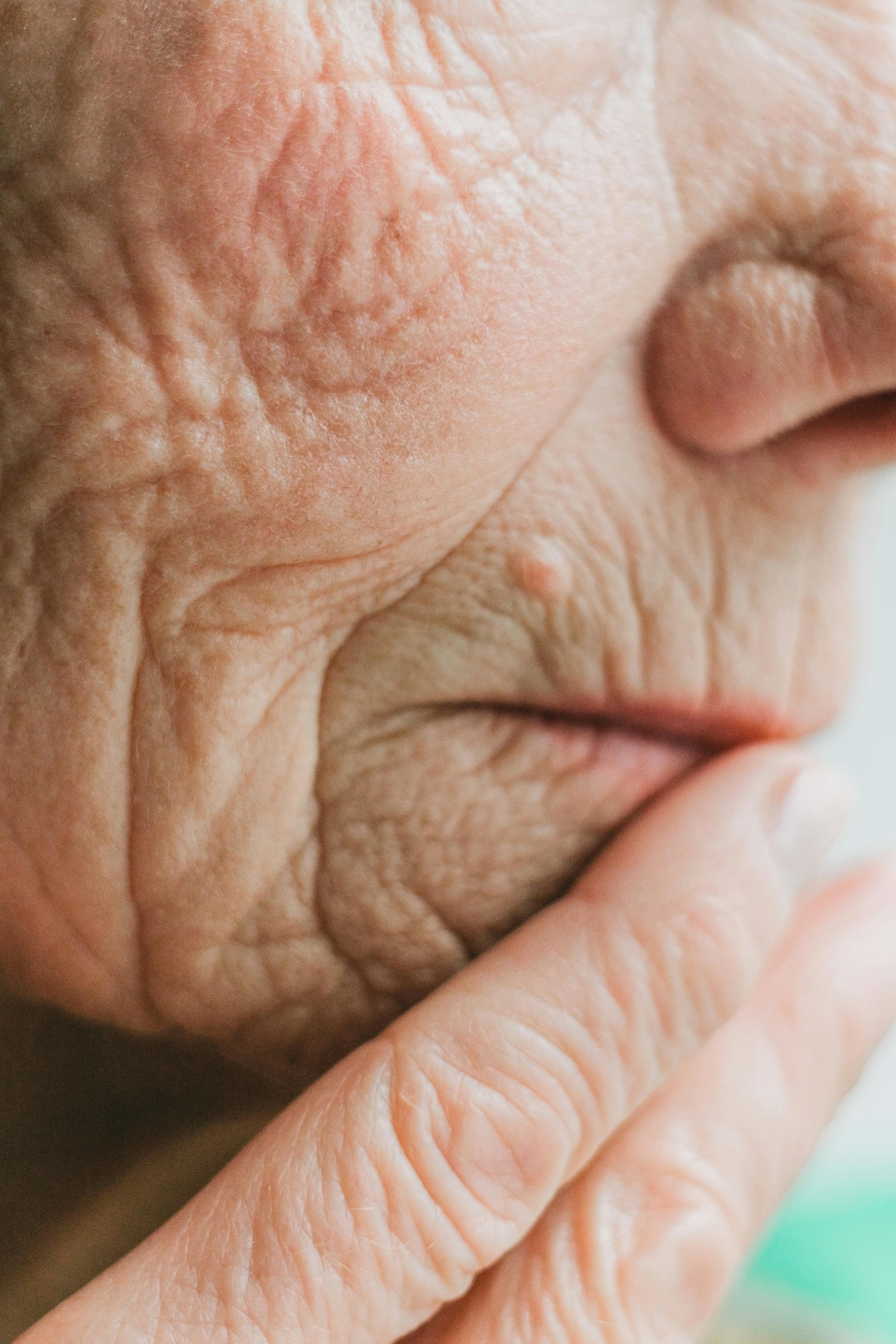 close up shot of an old person with wrinkles on face