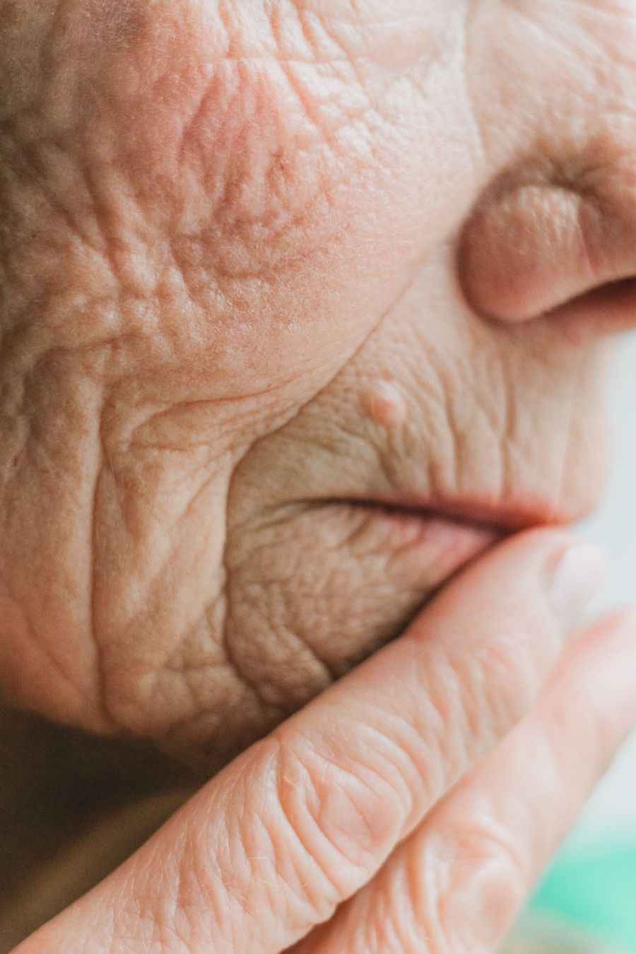Close-up of an older person's hand and skin showing natural signs of ageing