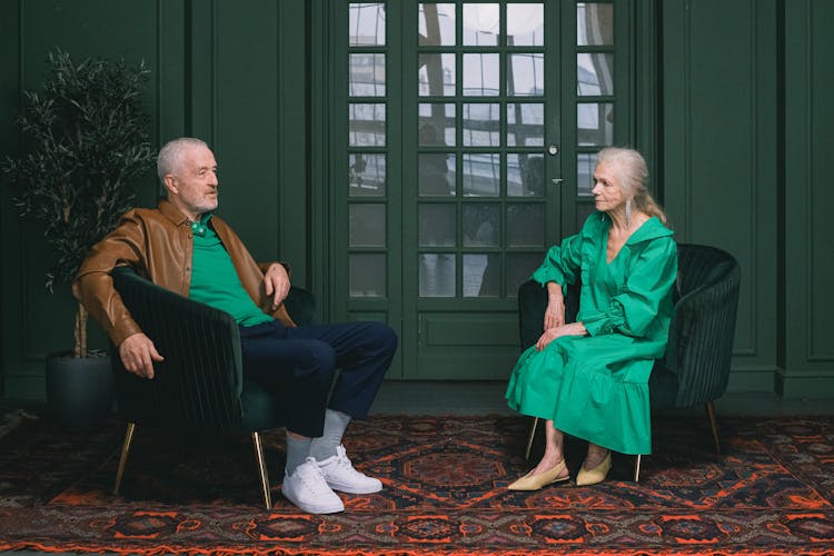 Elderly Couple Sitting In Chairs Talking