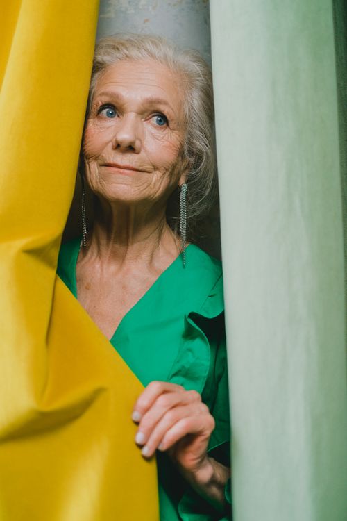 Free Elegantly dressed senior woman in vibrant surroundings, exuding confidence and style. Stock Photo