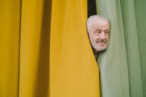 Free An Elderly Man Behind the Curtain Stock Photo