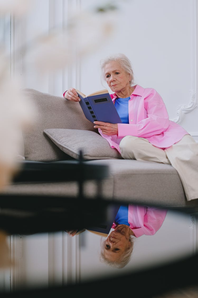 A Elderly Woman Reading A Book