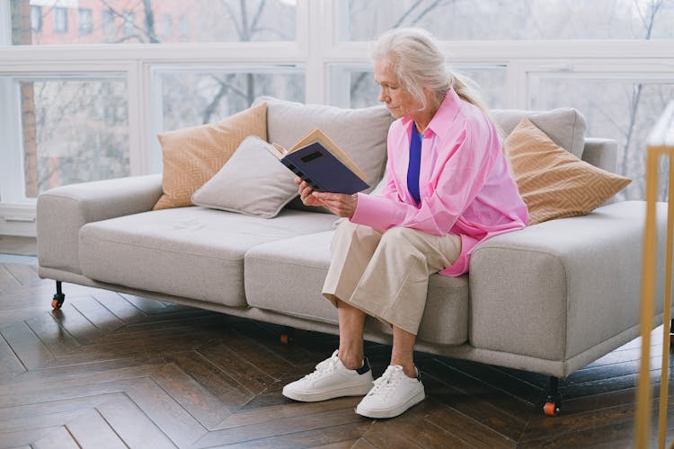 An Elderly Woman Reading A Book