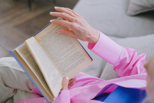 Free Overhead Shot of a Person Reading a Book Stock Photo