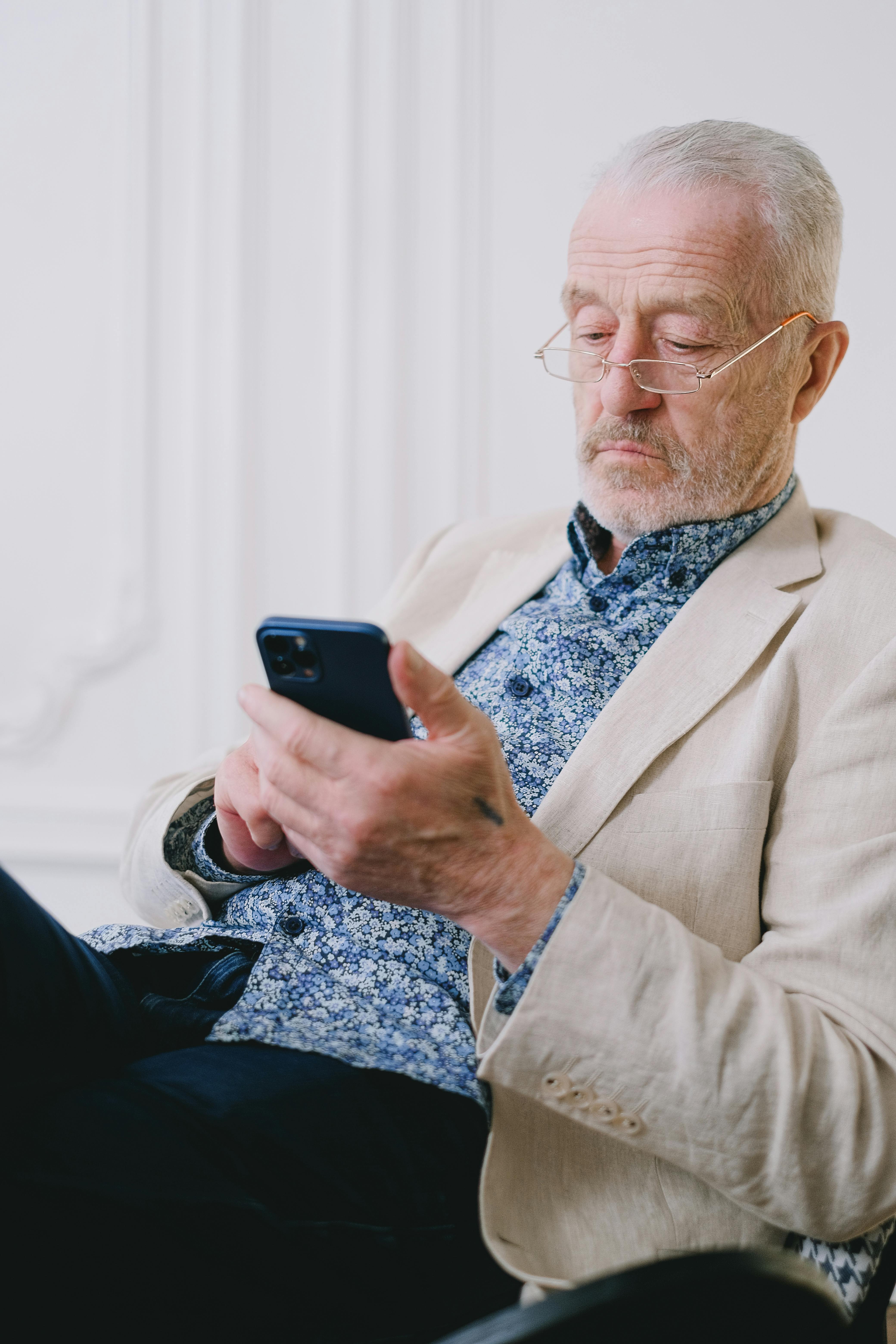 an elderly man using his cell phone