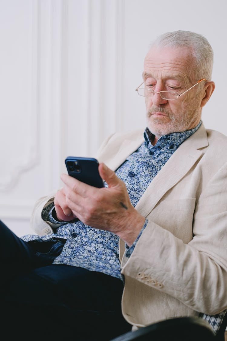 An Elderly Man Using His Cell Phone