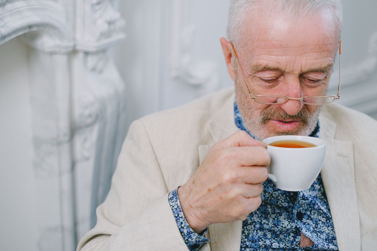 Senior man enjoying a warm cup of herbal tea