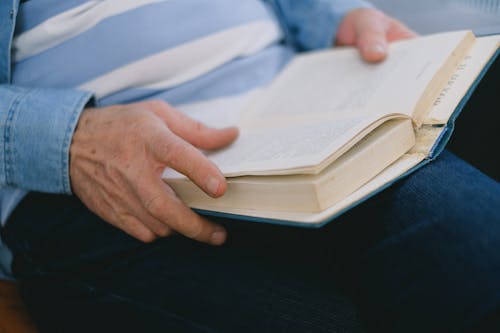 Close Up Shot of a Person Holding a Book