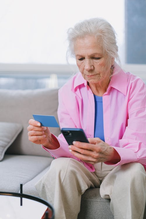 Elderly Woman using Smartphone and Card