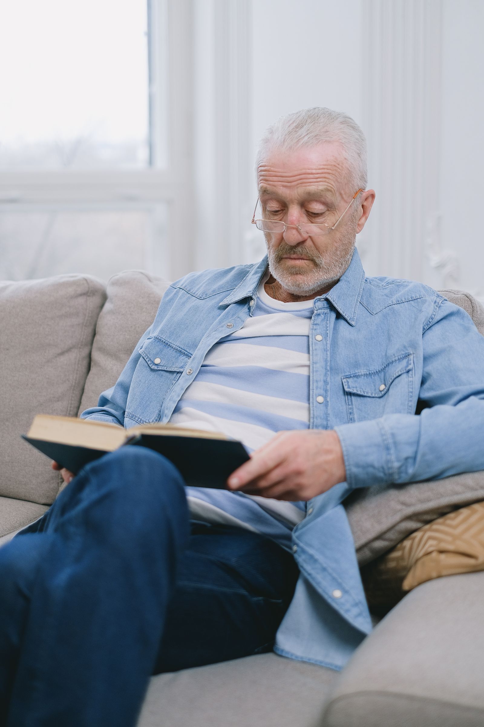 Mature man relaxing with a book in the evening