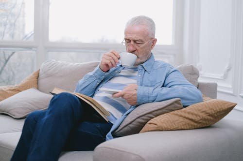 Free An Elderly Man with Eyeglasses Drinking from a White Cup Stock Photo