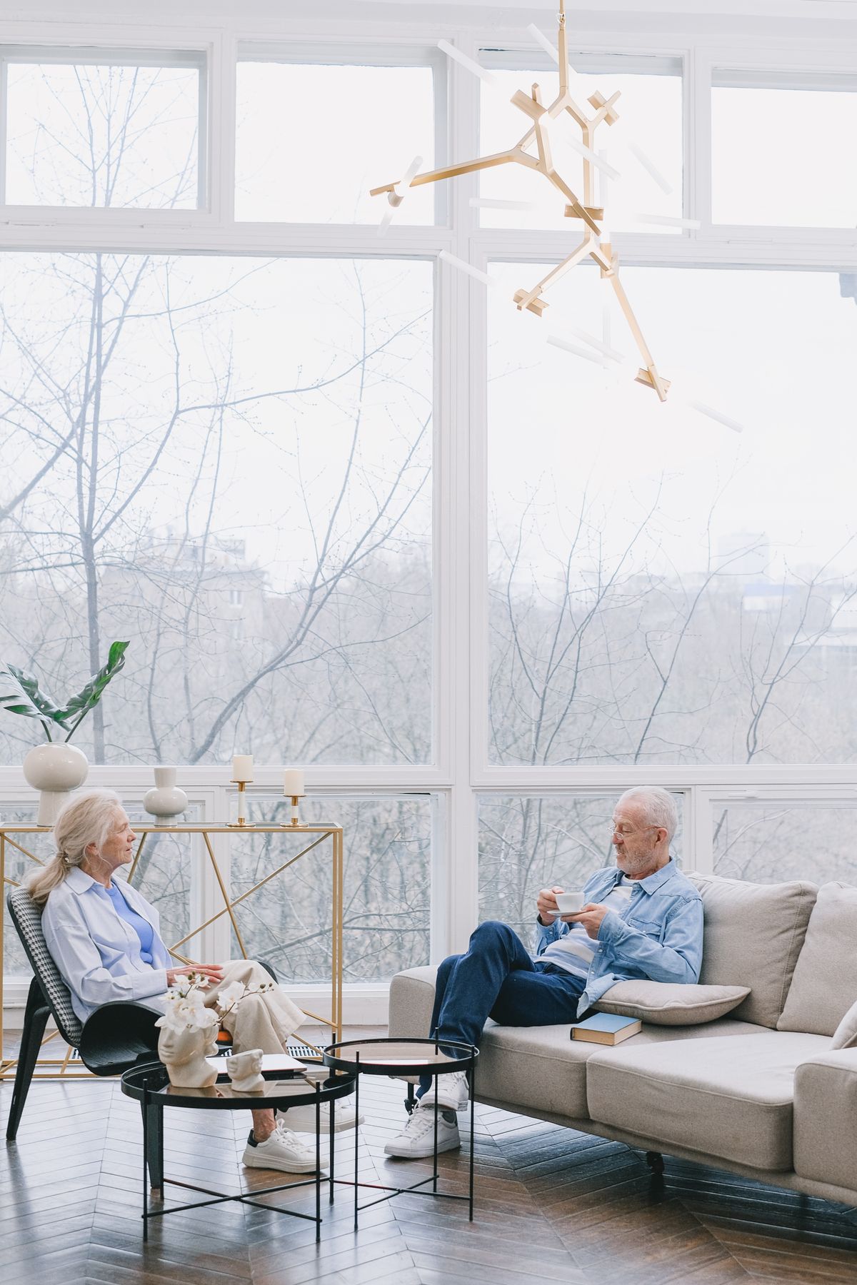 Older couple relaxing together in a bright premium living room