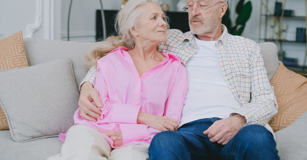Senior couple relaxing together on a sofa in their comfortable home