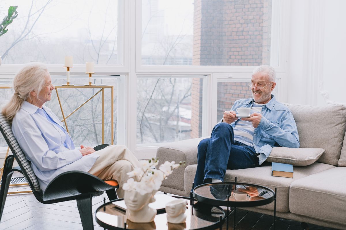 Senior couple enjoying tea together, relaxed in their own home in central Connecticut