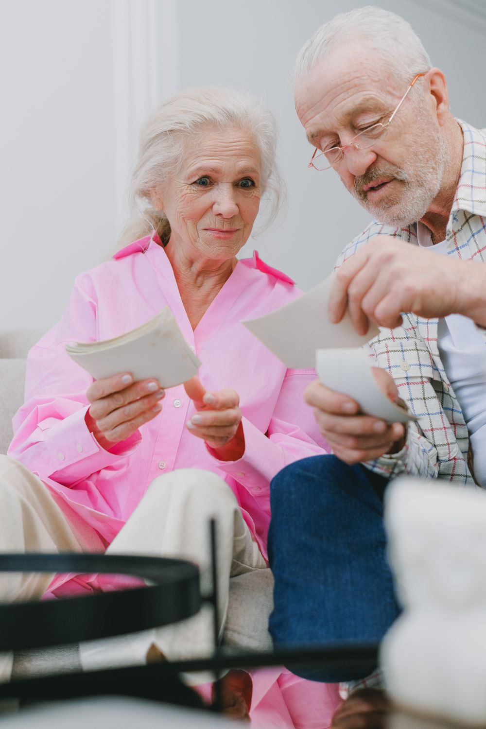 An Elderly Couple Looking at Photographs · Free Stock Photo