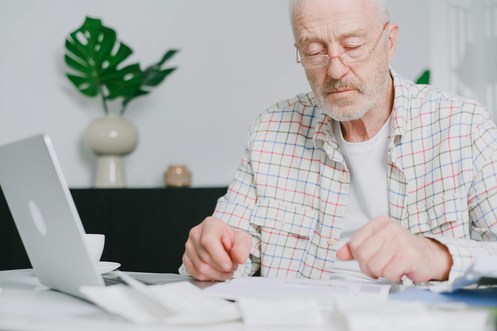 Elderly man focused on paperwork